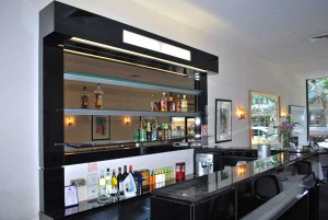 Glass shelves behind bar. Restaurant bar and counter